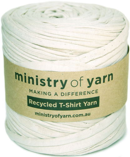 A spool of beige recycled T-shirt yarn wrapped with a brown paper label that reads 'ministry of yarn' and 'Recycled T-Shirt Yarn'.