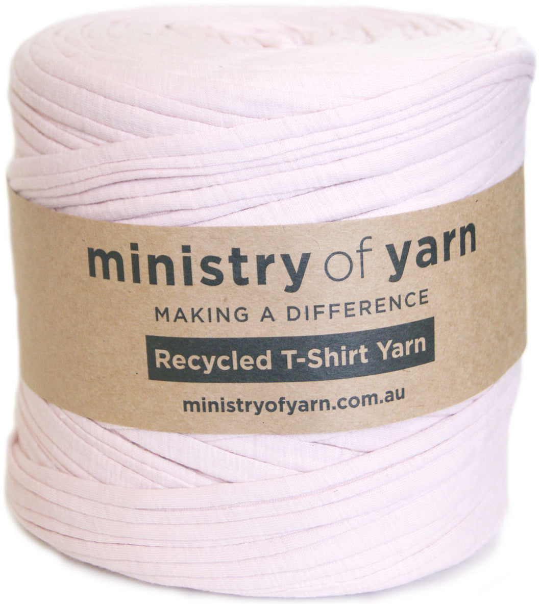A roll of light pink recycled T-shirt yarn wrapped with a brown paper label that reads 'ministry of yarn' and 'Recycled T-Shirt Yarn'.