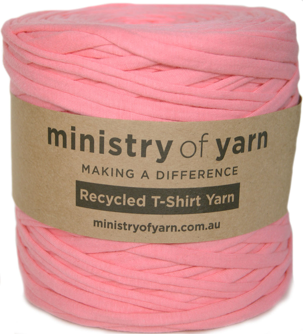 A skein of pink recycled T-shirt yarn wrapped in a brown paper label that reads 'ministry of yarn' and 'Recycled T-Shirt Yarn'.
