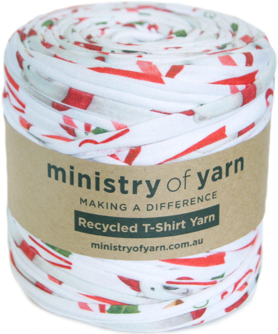 A roll of Ministry of Yarn recycled T-shirt yarn with a white base and a festive red, green, and blue holiday print, wrapped in a brown paper label.