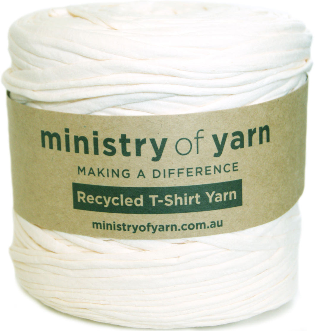 A spool of off-white recycled t-shirt yarn wrapped with a brown paper label that reads 'ministry of yarn' and 'Recycled T-Shirt Yarn'.