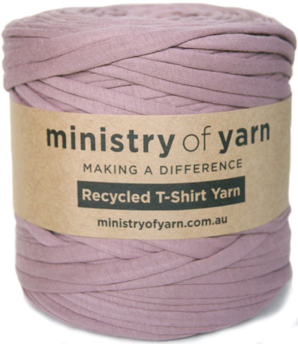 A ball of dusty purple recycled T-shirt yarn wrapped with a brown paper label that reads 'ministry of yarn' and 'Recycled T-Shirt Yarn'.