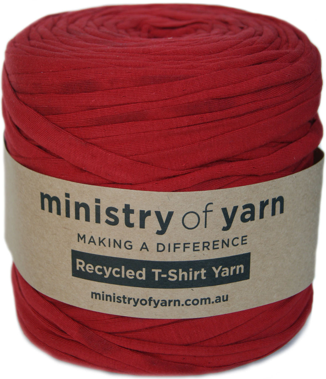 A roll of red recycled T-shirt yarn wrapped in a kraft paper label that reads 'ministry of yarn'.