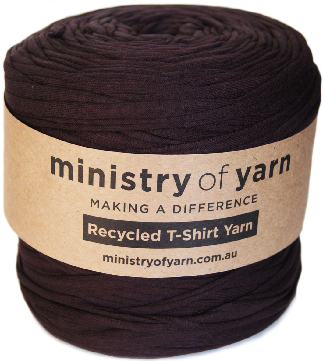 Spool of dark brown yarn with 'ministry of yarn' label on a white background