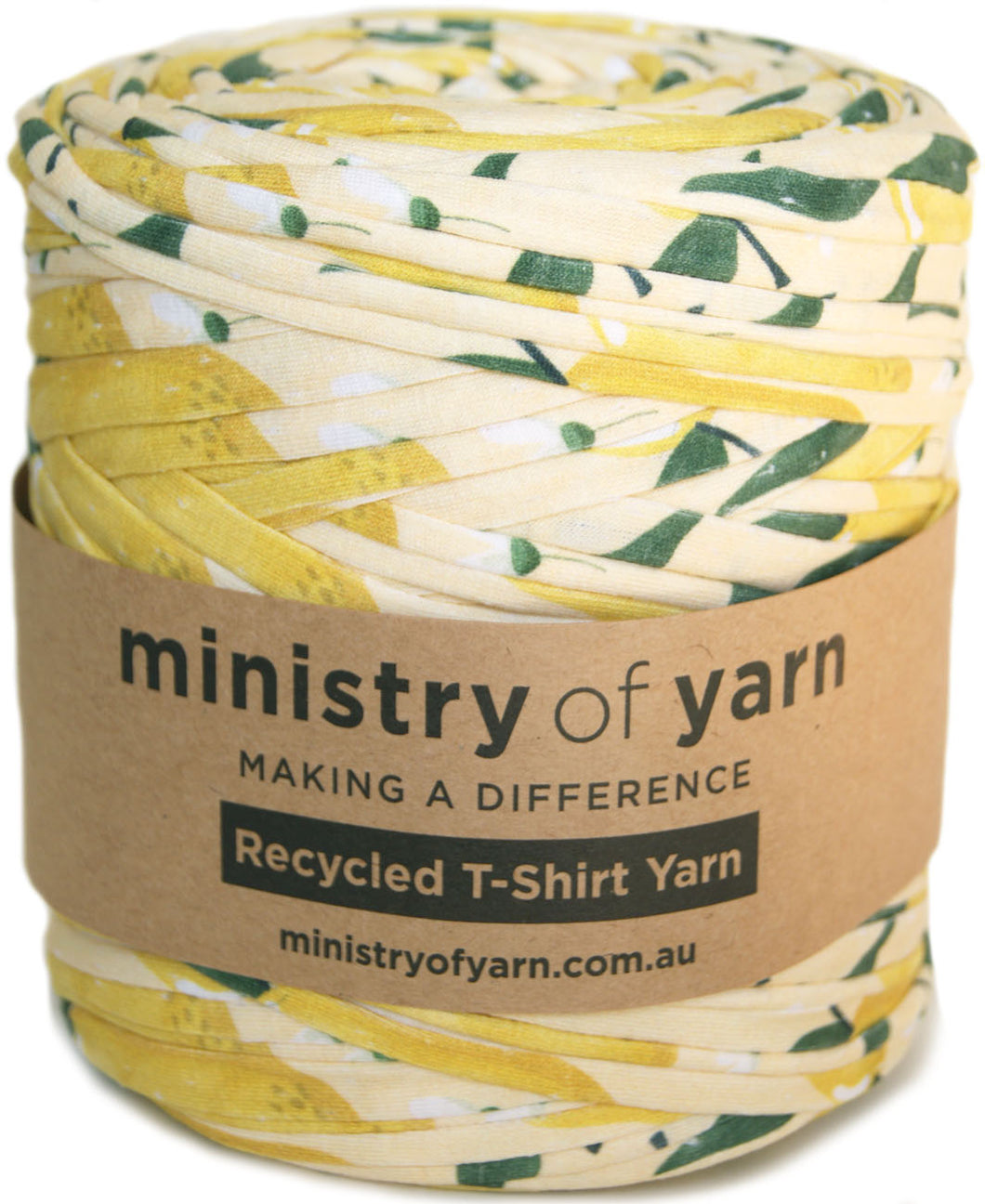 A spool of Ministry of Yarn recycled T-shirt yarn with a yellow, green, and off-white pattern, wrapped in a brown paper label.
