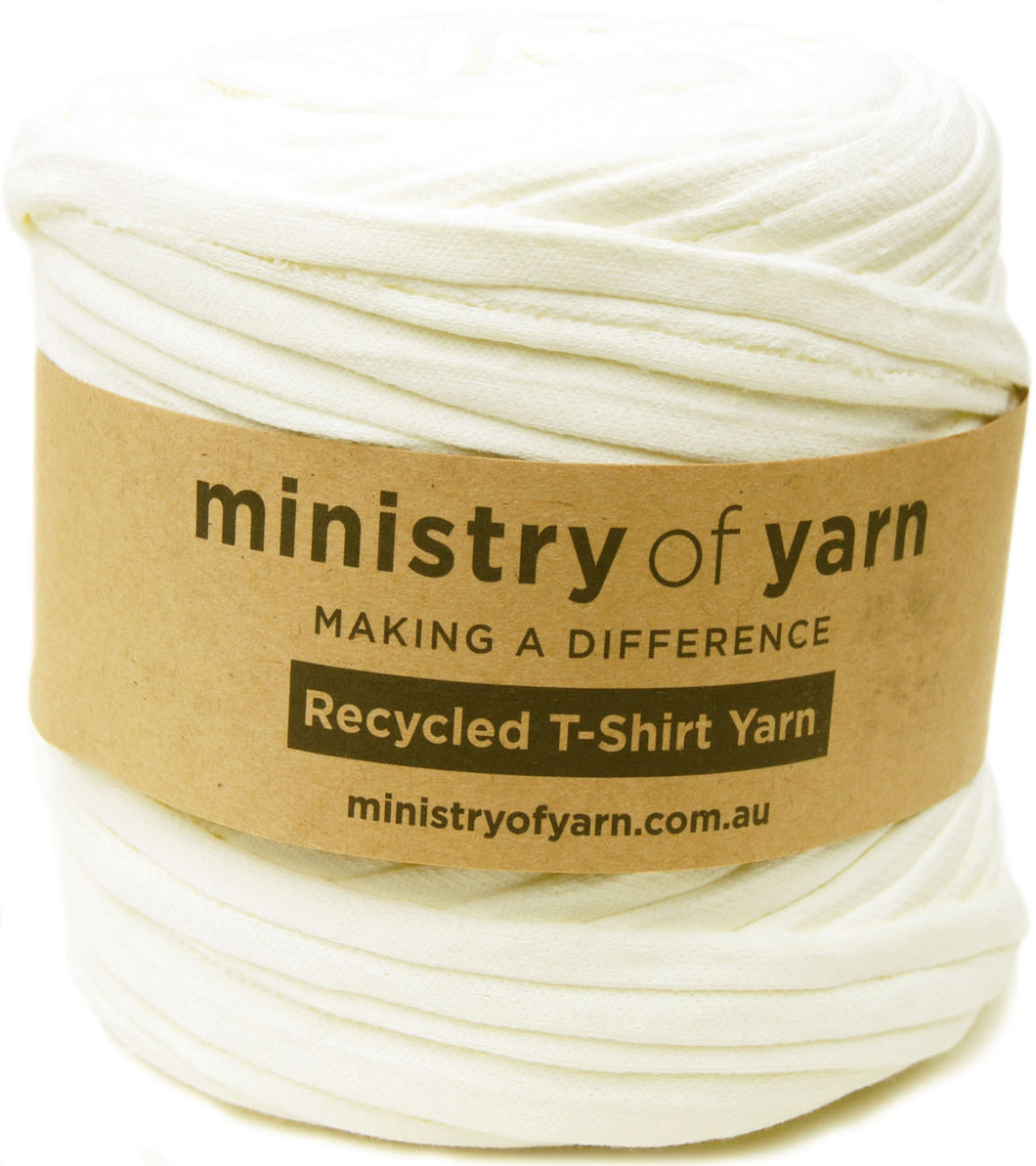 A spool of creamy yellow recycled T-shirt yarn wrapped with a brown paper label that reads 'ministry of yarn' and 'Recycled T-Shirt Yarn'.