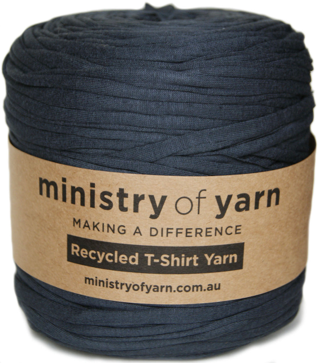 A skein of dark grey recycled t-shirt yarn wrapped with a brown paper label that reads 'ministry of yarn'.