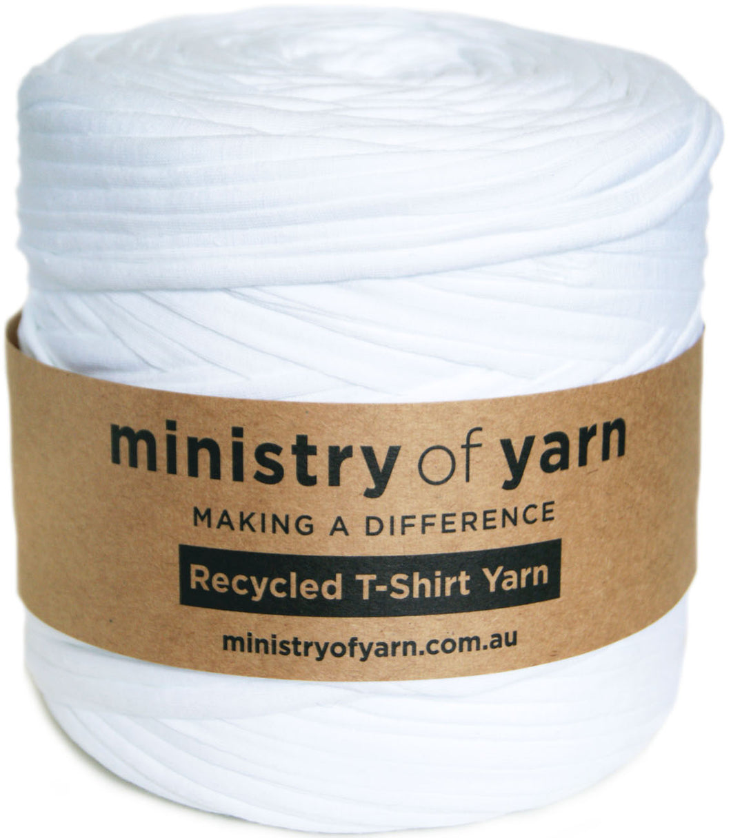 A spool of white recycled T-shirt yarn wrapped with a brown kraft paper label that reads 'ministry of yarn' and 'Recycled T-Shirt Yarn'.