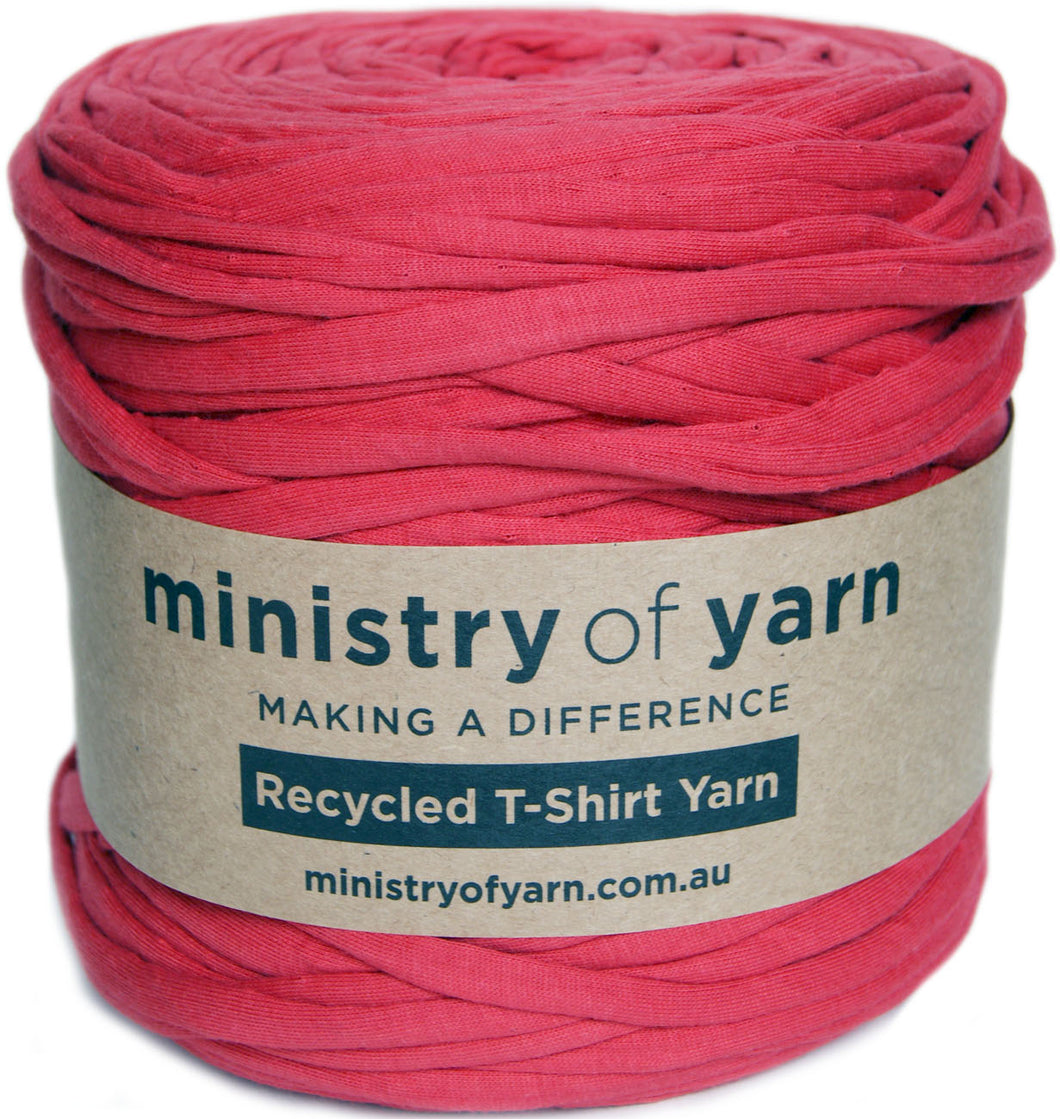 A large spool of light red recycled T-shirt yarn wrapped with a kraft paper label that reads 'ministry of yarn' and 'Recycled T-Shirt Yarn'.