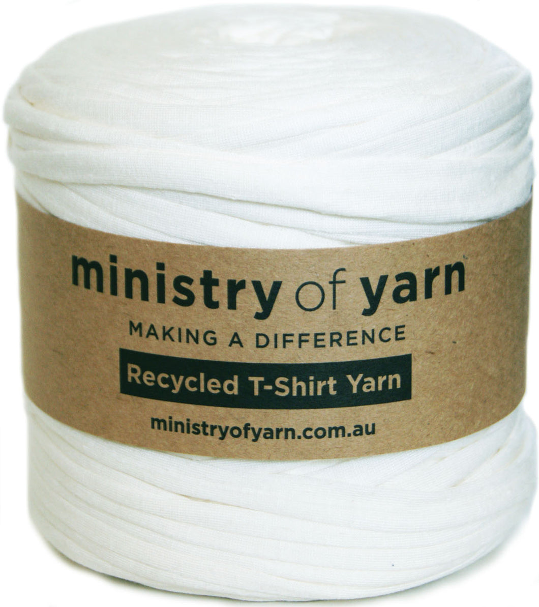 A spool of white recycled T-shirt yarn wrapped with a brown kraft paper label that reads 'ministry of yarn' and 'Recycled T-Shirt Yarn'.