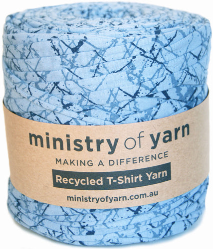 Spool of blue yarn with 'ministry of yarn' label on a white background