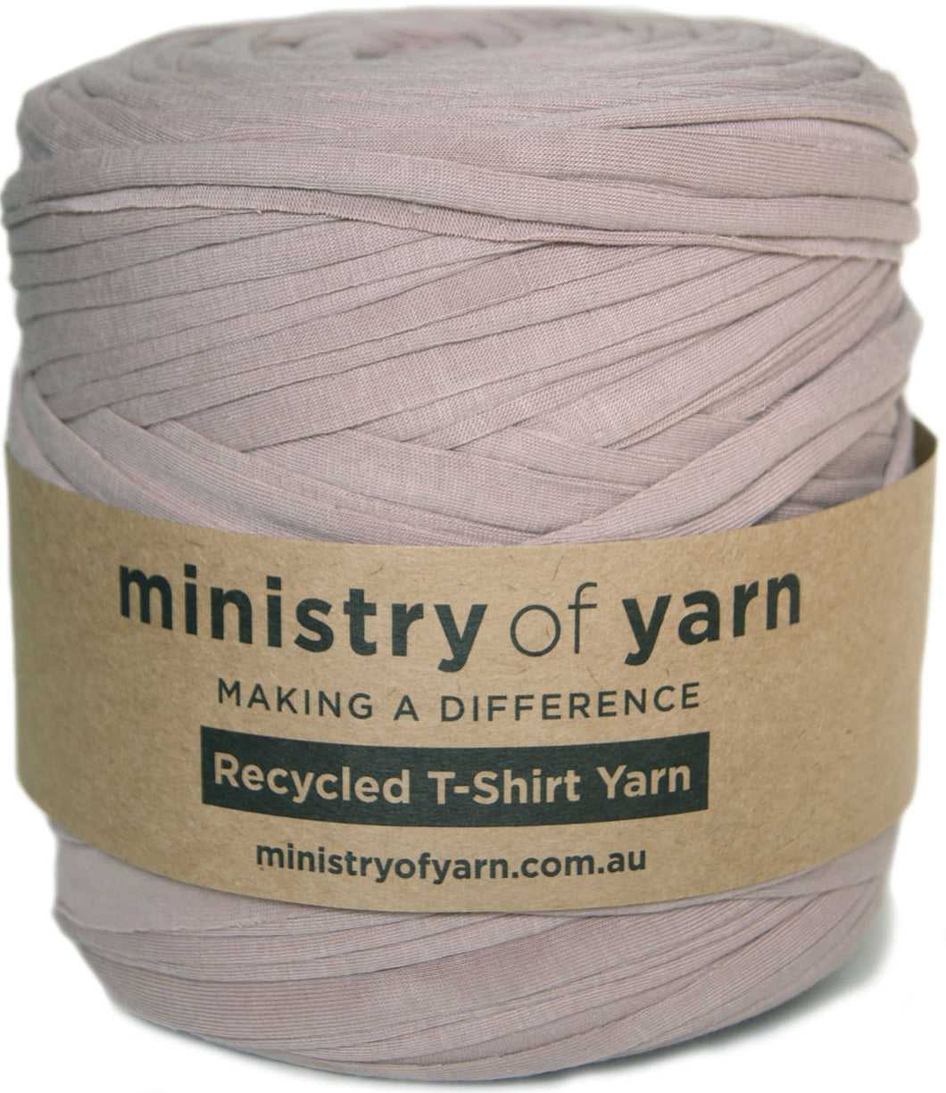 A ball of dusty brown recycled T-shirt yarn wrapped in a brown kraft paper label that reads 'ministry of yarn'.