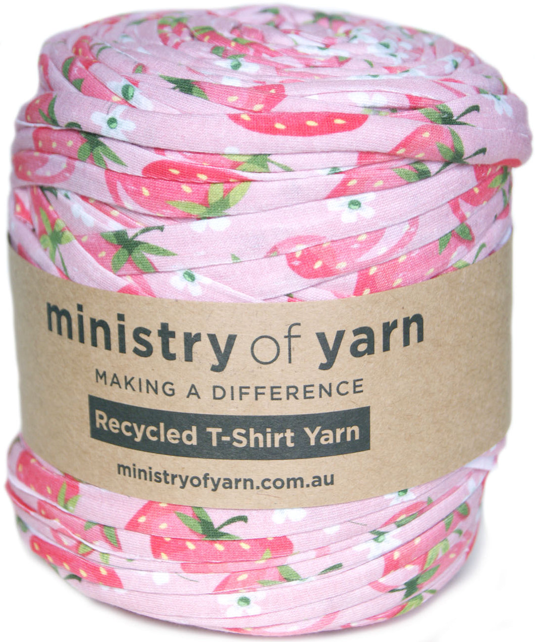 A roll of pink T-shirt yarn with a strawberry print pattern, wrapped in a brown paper label that reads 'ministry of yarn'.