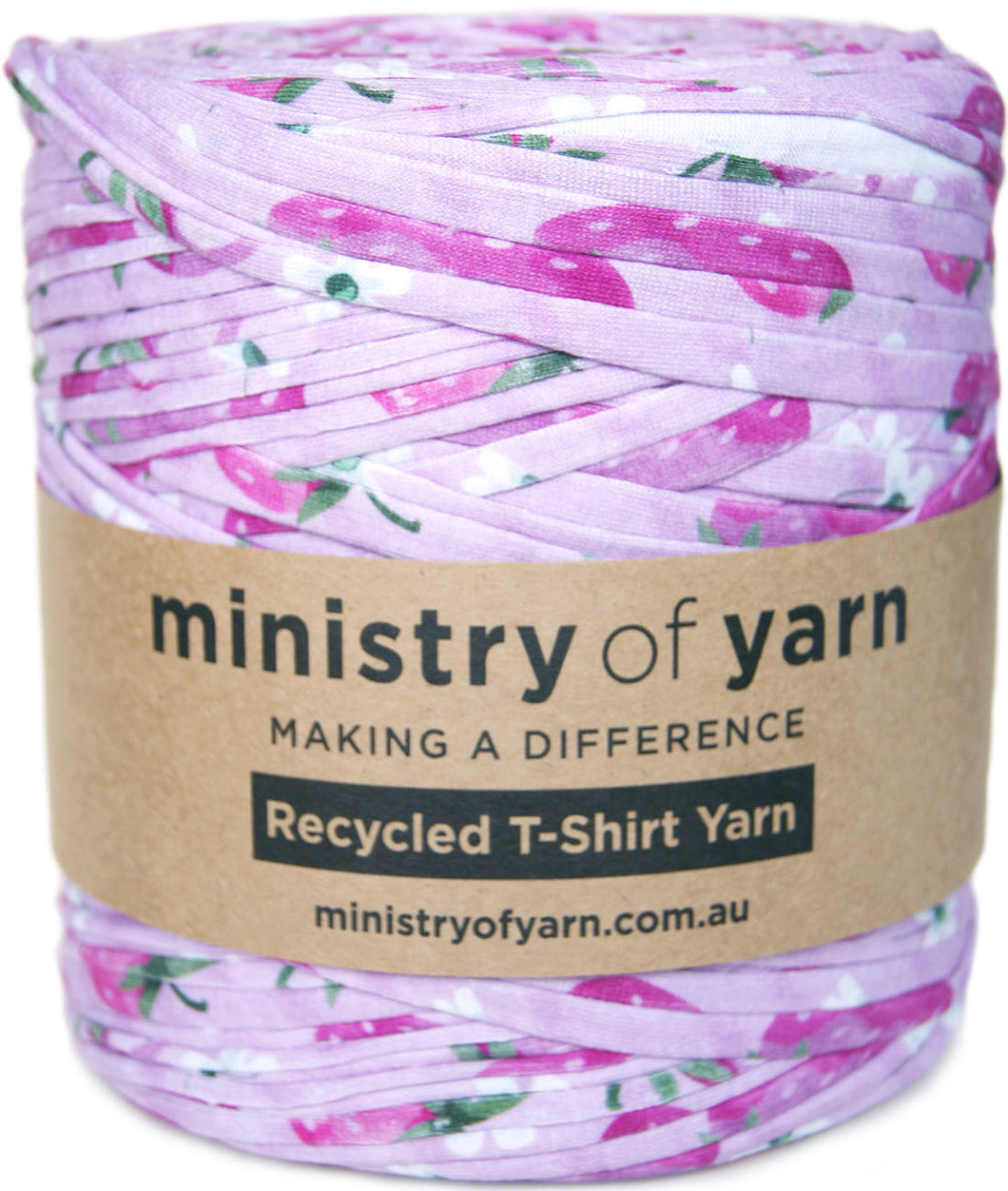 A spool of Ministry of Yarn recycled T-shirt yarn with a pink and purple strawberry pattern, wrapped in a brown paper label.