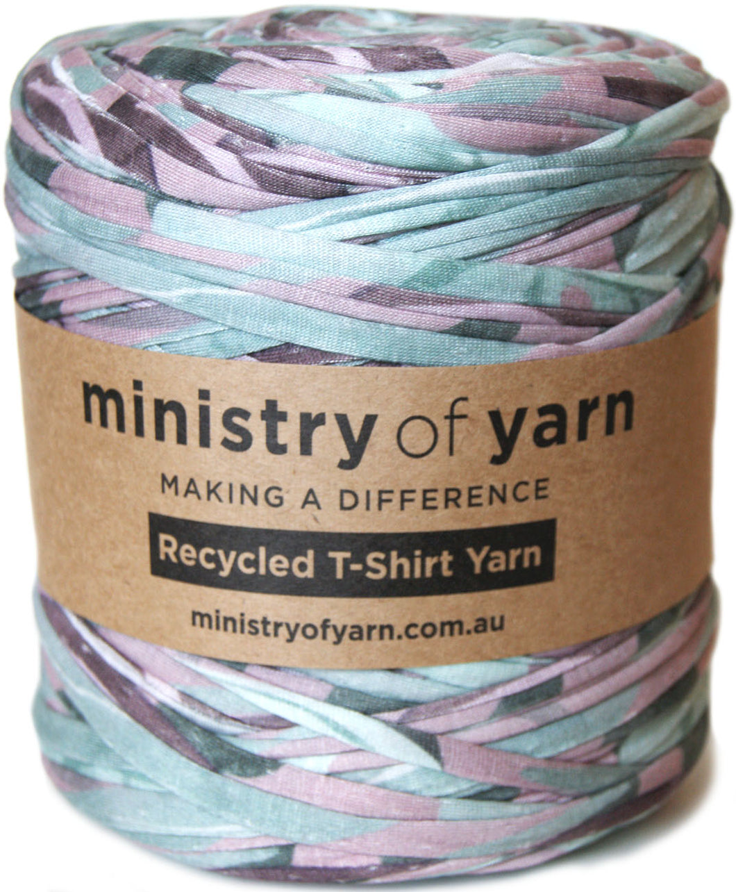 A spool of Ministry of Yarn recycled T-shirt yarn wrapped in a brown paper label, featuring a multicolor pattern of faded pink, teal, and gray.