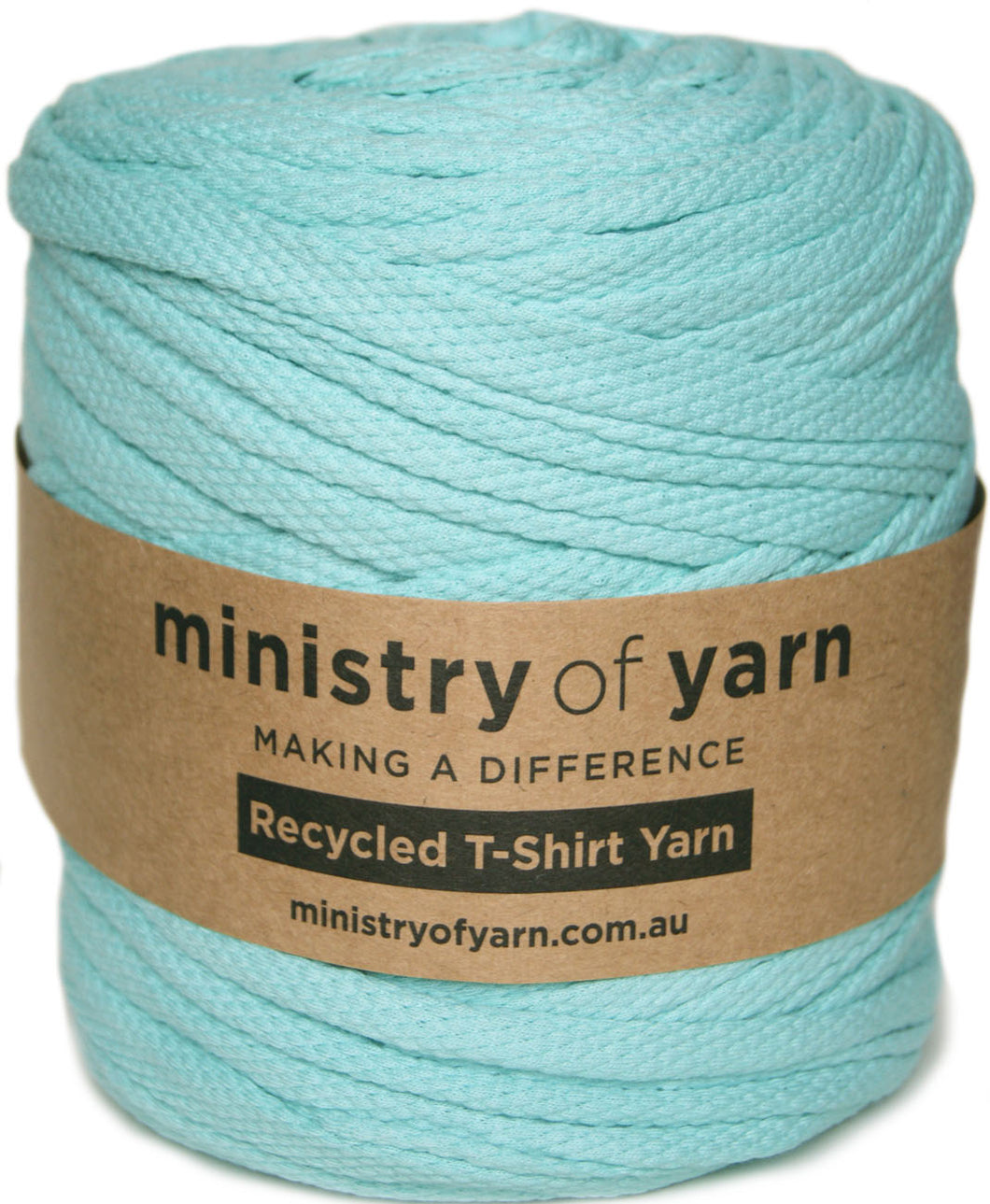 A spool of mint green recycled T-shirt yarn wrapped with a brown paper label that reads 'ministry of yarn'.