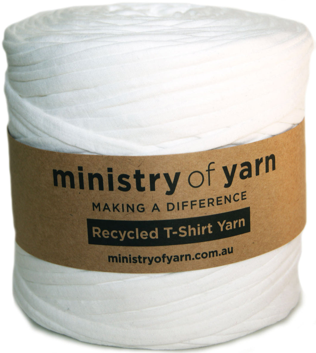 A white spool of Ministry of Yarn recycled T-shirt yarn wrapped with a brown paper label.